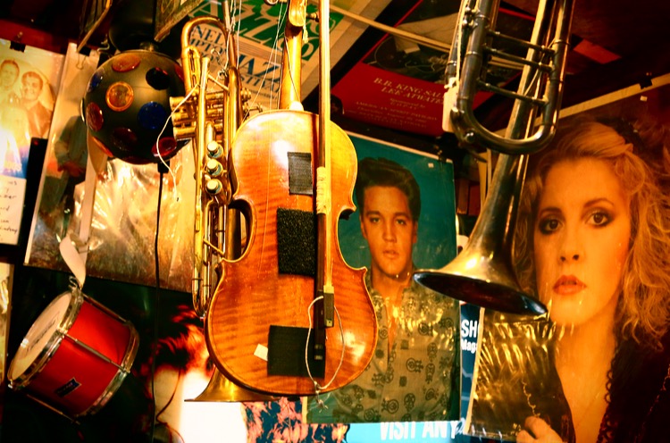 wall of musical instruments and posters