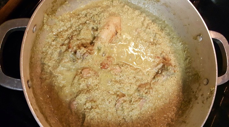 cooking chicken in Pipián sauce in pot