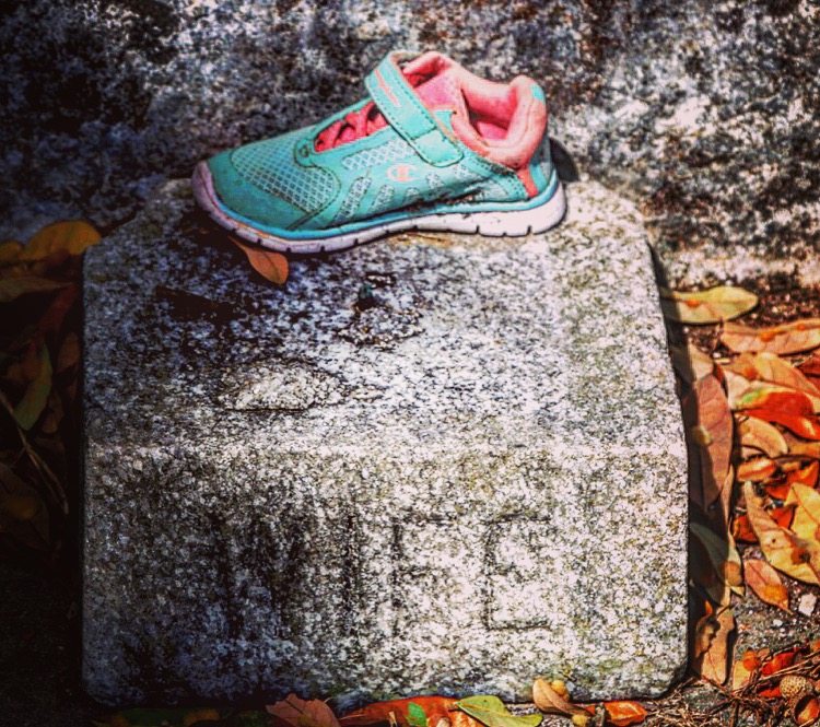 child's sneaker on a tombstone in Lafayette Cemetery, New Orleans