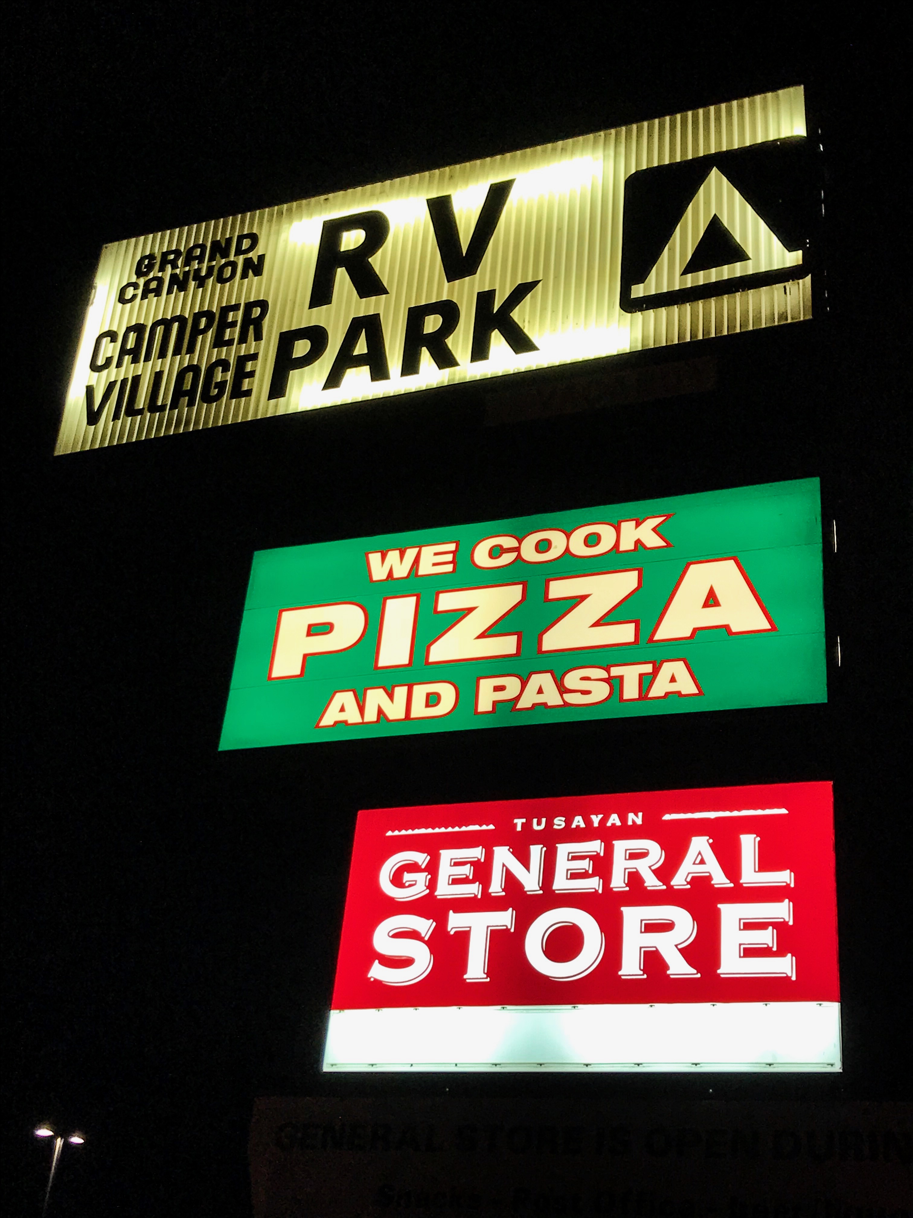 Grand Canyon RV Park Camper village signs at night
