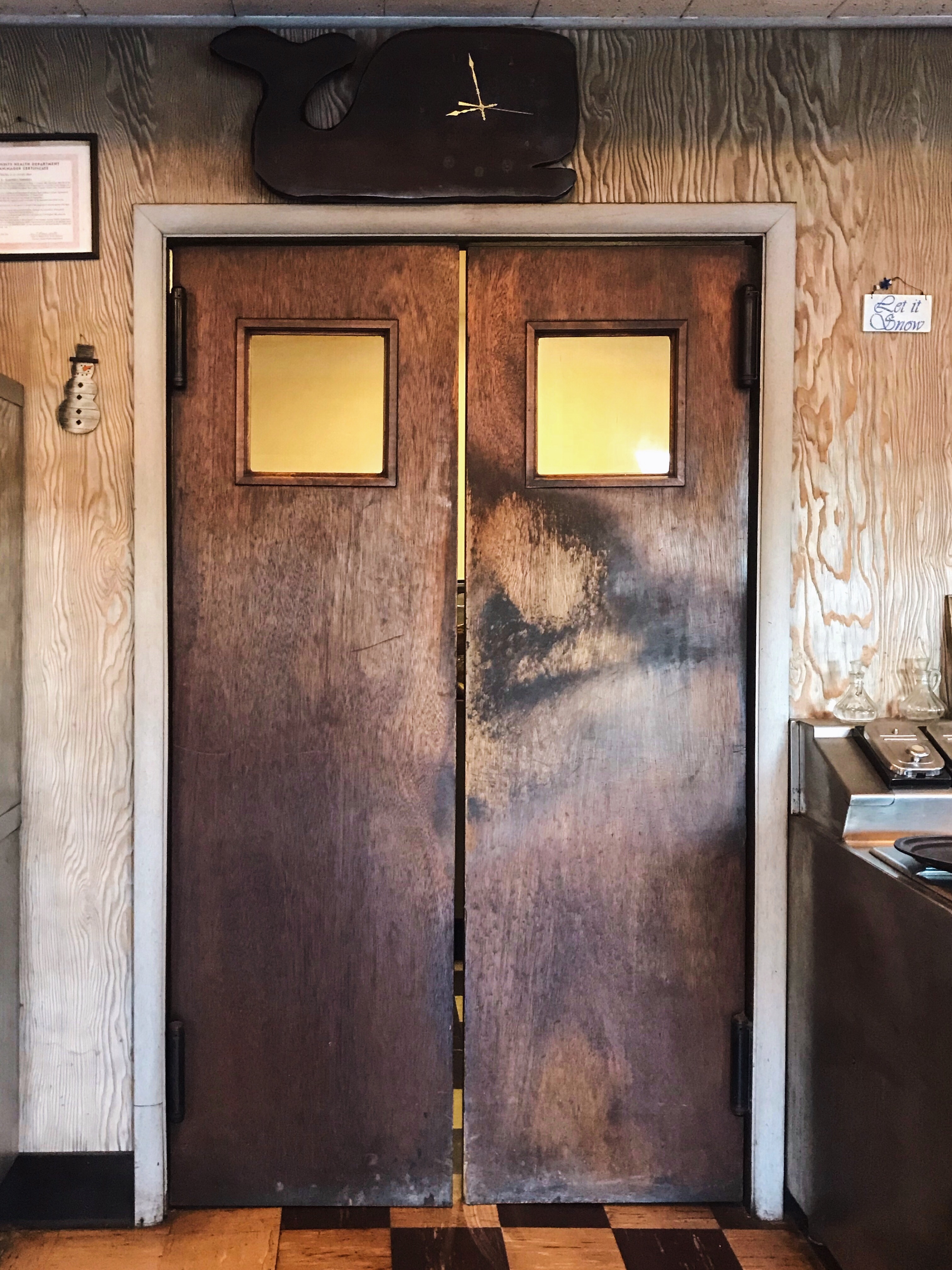 Door to the kitchen with Whale clock above it at The Fisherman Restaurant, Phoenixville, Pennsylvania