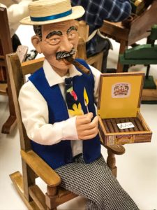 Man in rocking chair with Cuban cigars