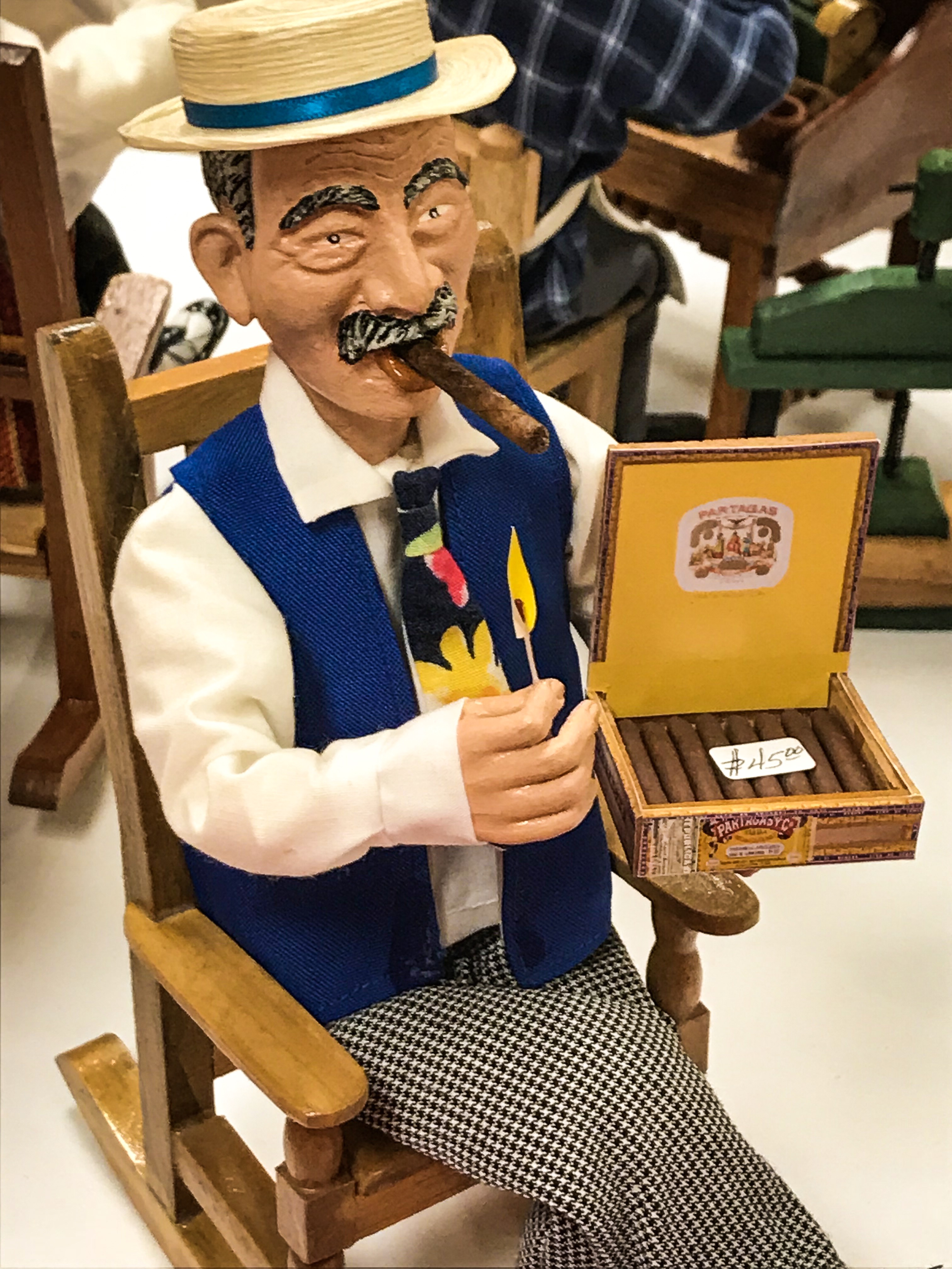 Man in rocking chair with Cuban cigars