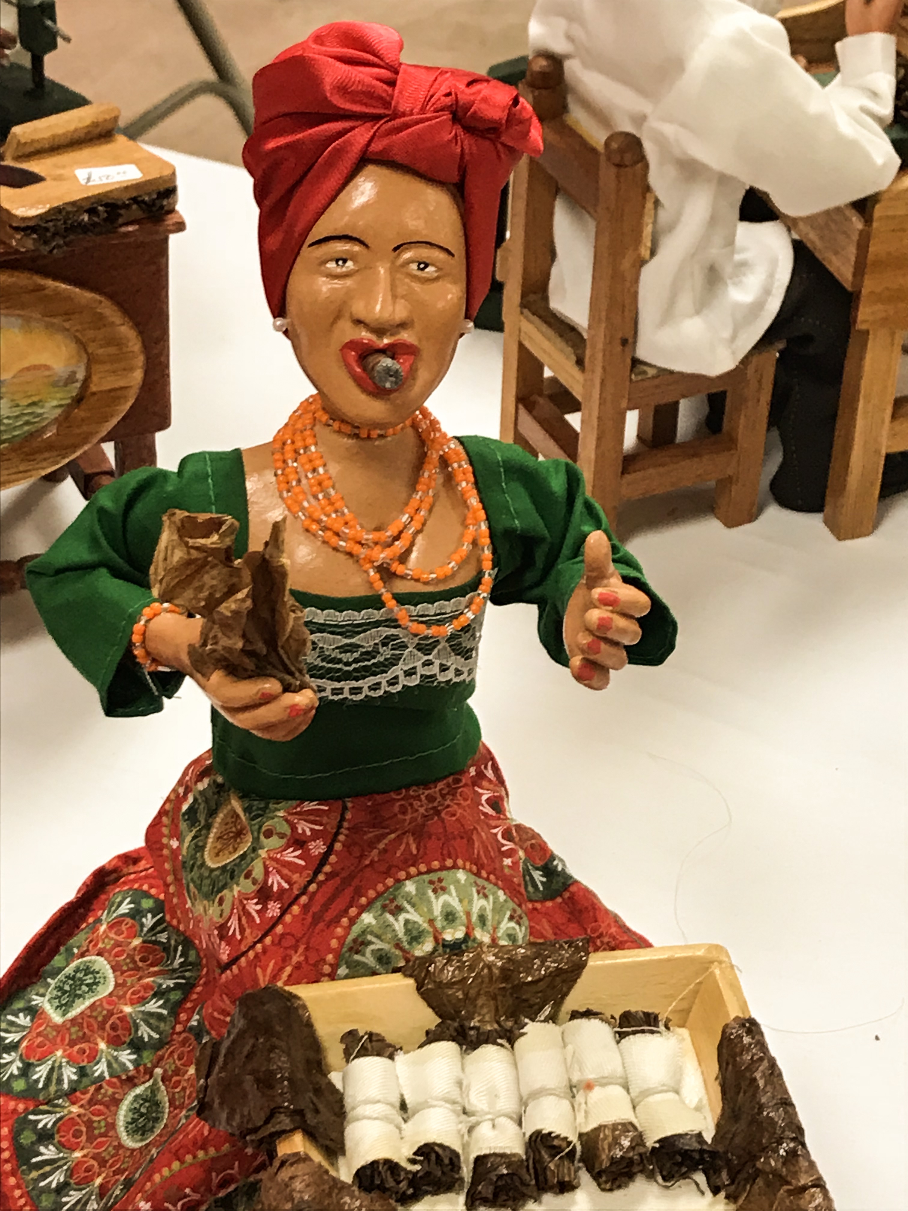 Woman with traditional Cuban dress and cigars